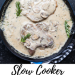 pork chops in a cast iron pan covered with a creamy mushroom gravy