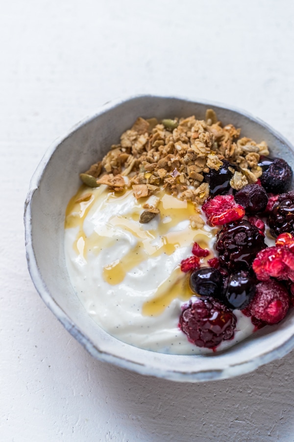 instant pot vanilla bean yogurt in a bowl with berries and granola
