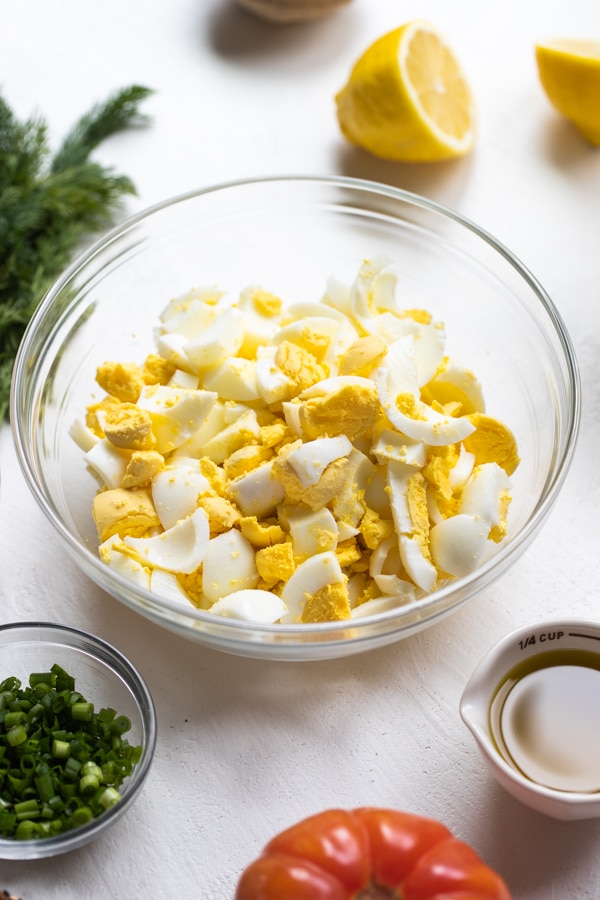 a glass bowl of chopped hard boiled eggs 