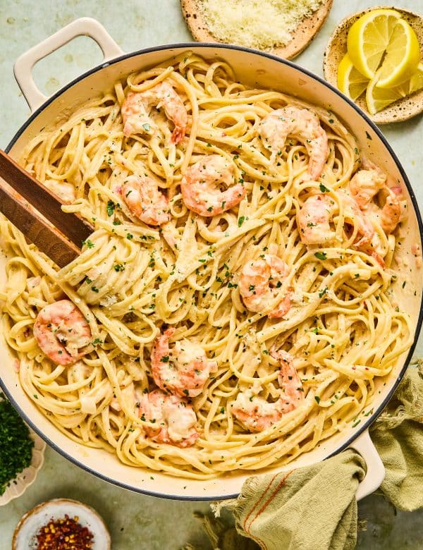 Bowl of linguine pasta in a white sauce with shrimp.