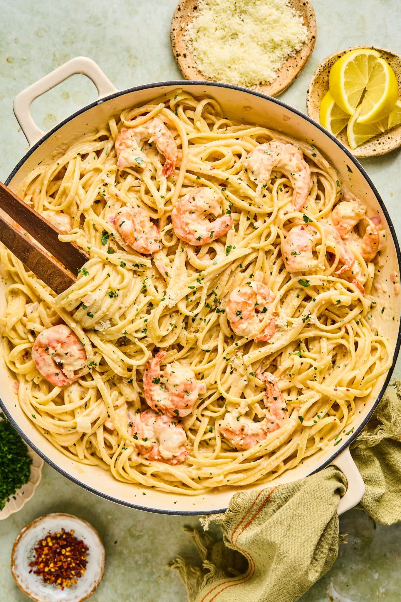 Bowl of linguine pasta in a white sauce with shrimp.