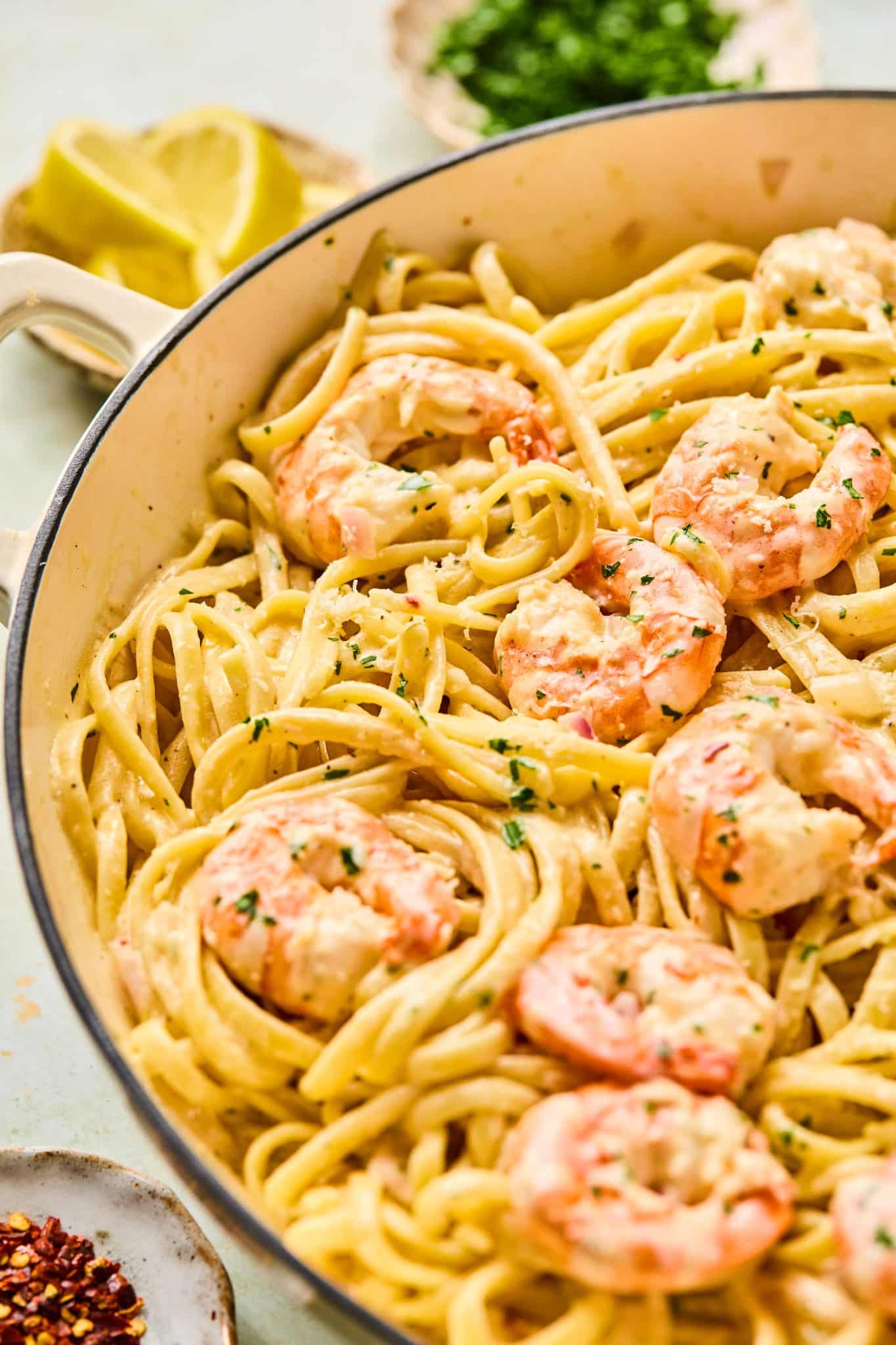 linguine pasta and shrimp in a bowl with fresh parsley.