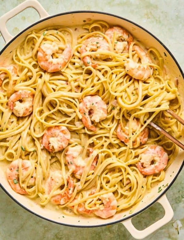 Bowl of linguine pasta in a white sauce with shrimp.