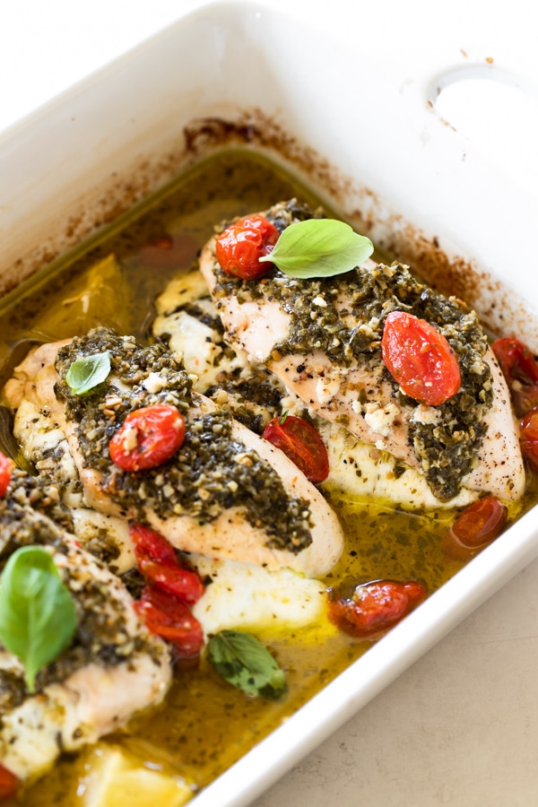 healthy pesto baked chicken in a baking pan