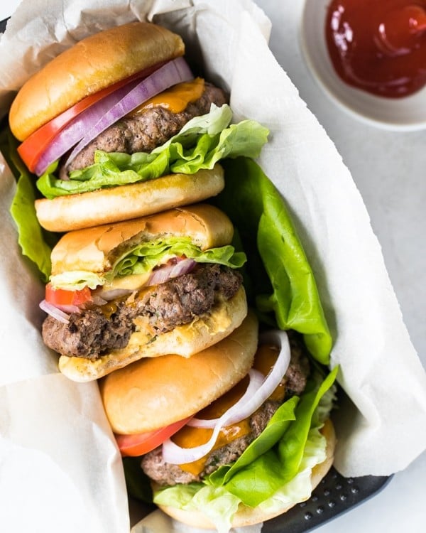 beef hamburgers with lettuce, onions, tomato and cheese