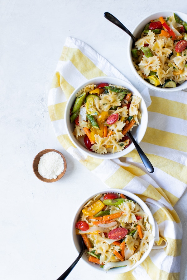 healthy pasta primavera in white bowls