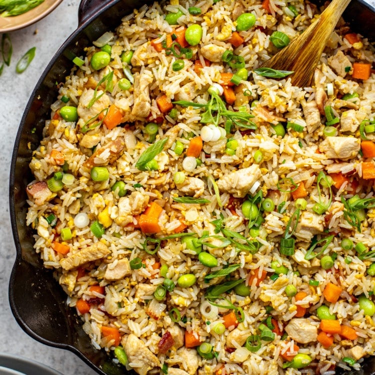 skillet with chicken fried rice and spoon