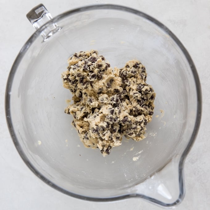 chocolate chip cookie dough in a glass mixing bowl