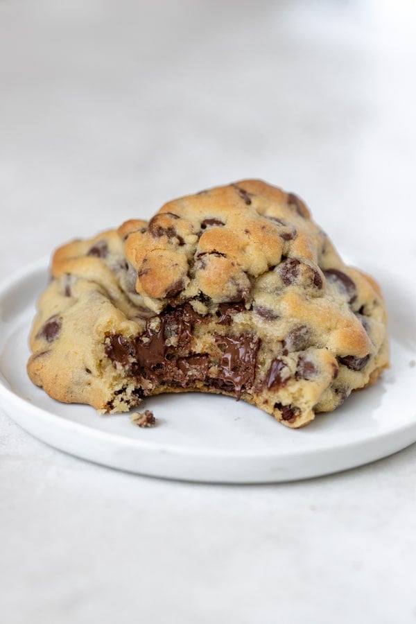 a giant chocolate chip cookie on a white plate