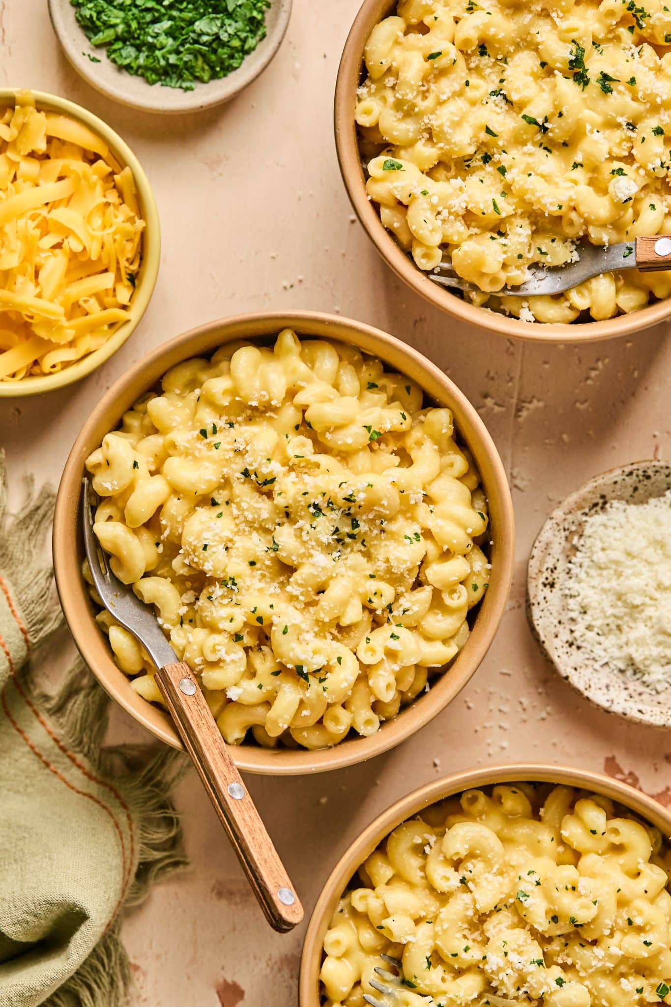 mac and cheese in a bowl topped with parsley. 