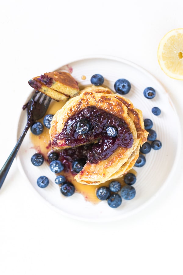 pancakes made with lemon and fresh blueberries on a white plate