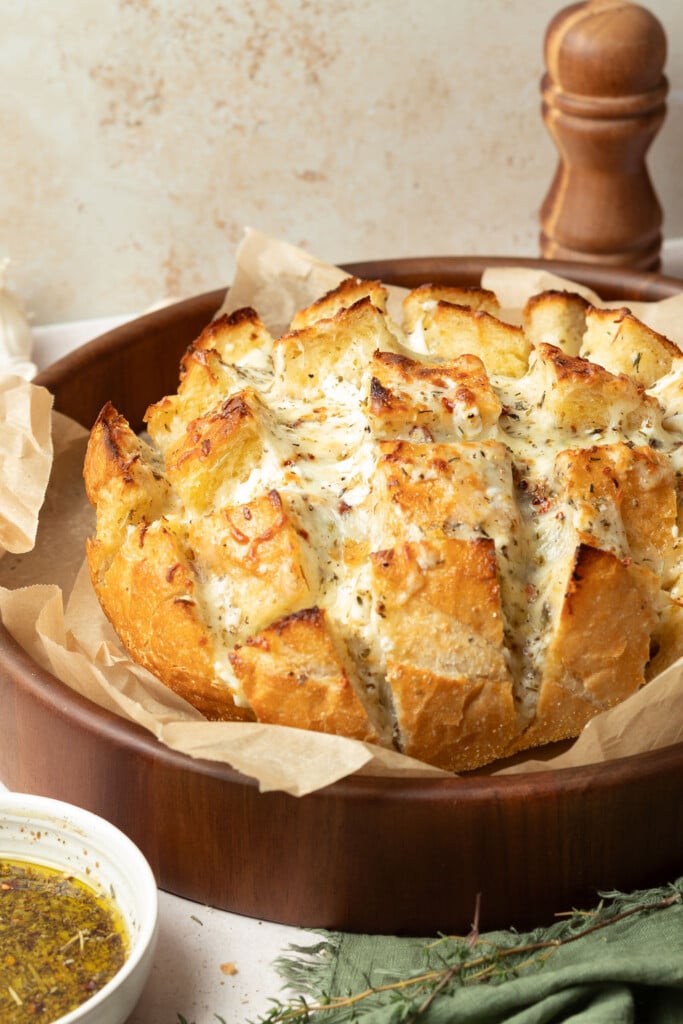 loaf of cheesy pull apart bread on serving dish