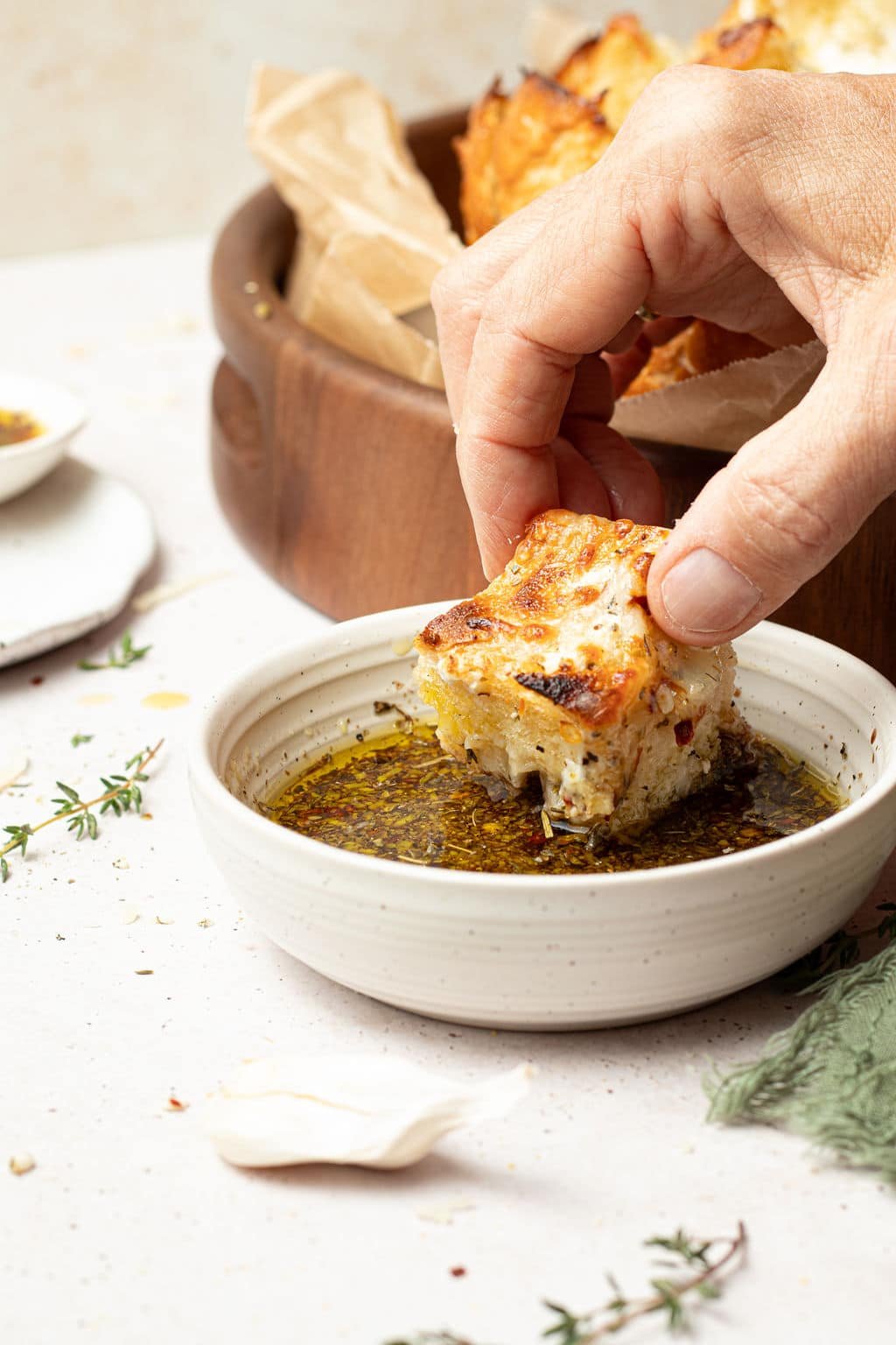 chunk of cheesy pull apart bread dipped in oil