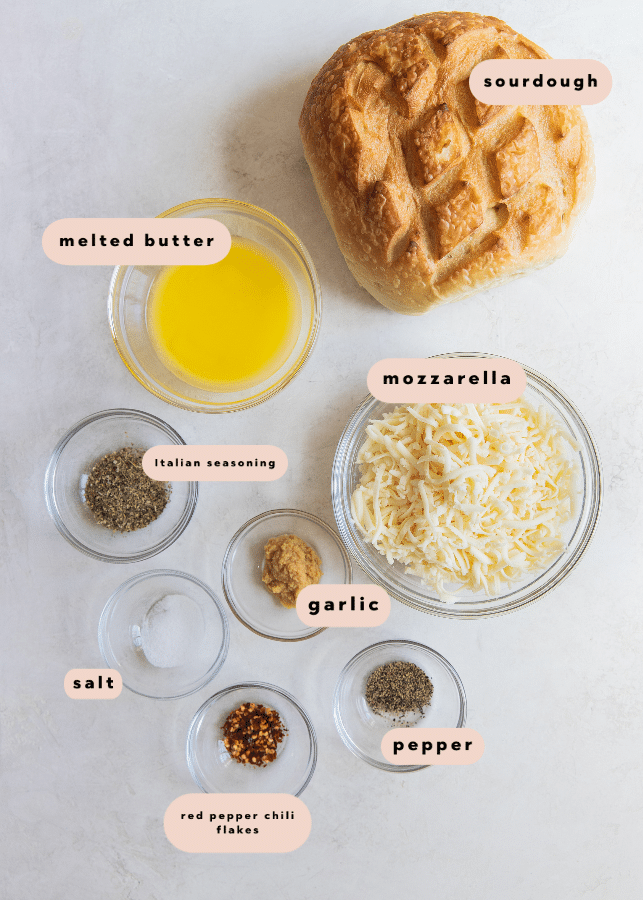 ingredients in glass bowls needed to make garlic pull apart bread