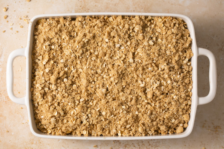 baking dish with apple pie bars topping layer