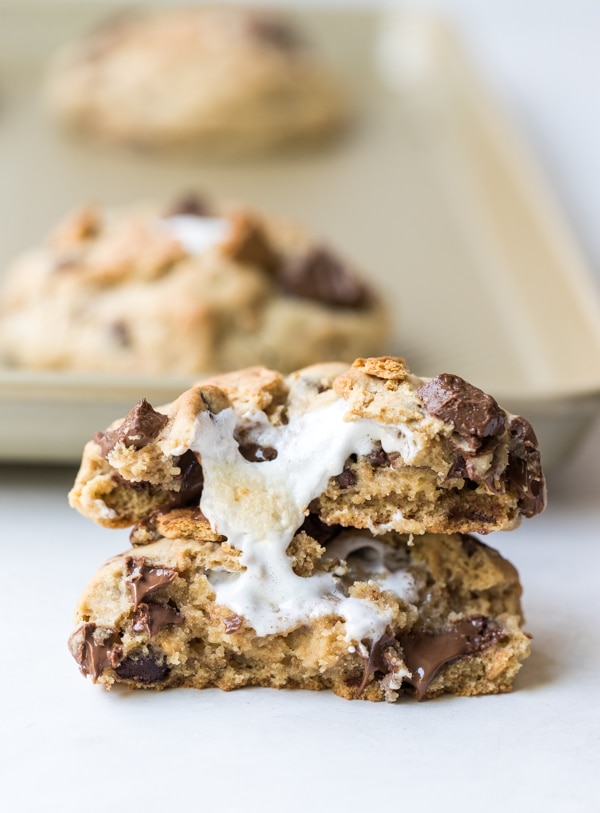 smores cookie recipe broken in half with a marshmallow in the center