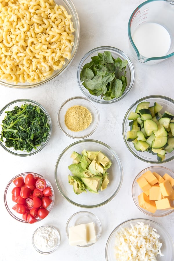 bowls with macaroni noodles, green vegetables, milk, tomatoes, cream, butter, and cheese