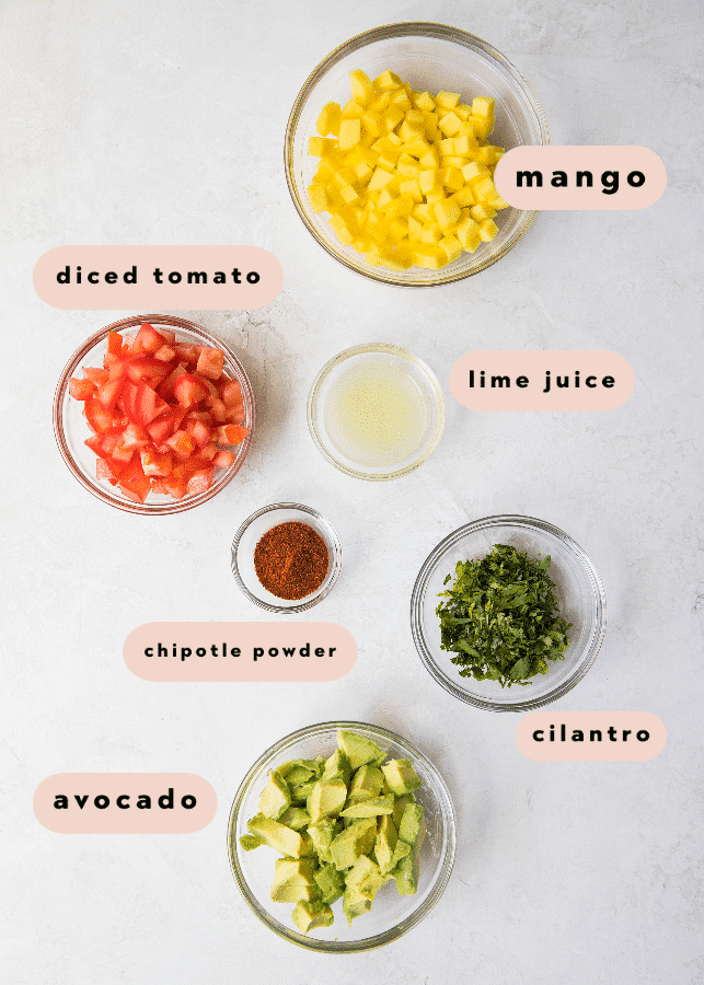 ingredients needed to make mango salsa in small glass bowls