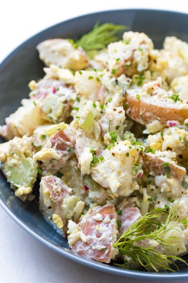 close of of potato salad in a blue bowl
