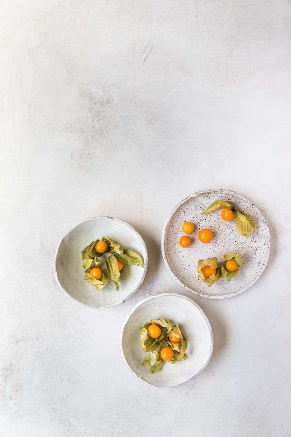 golden berries on plates