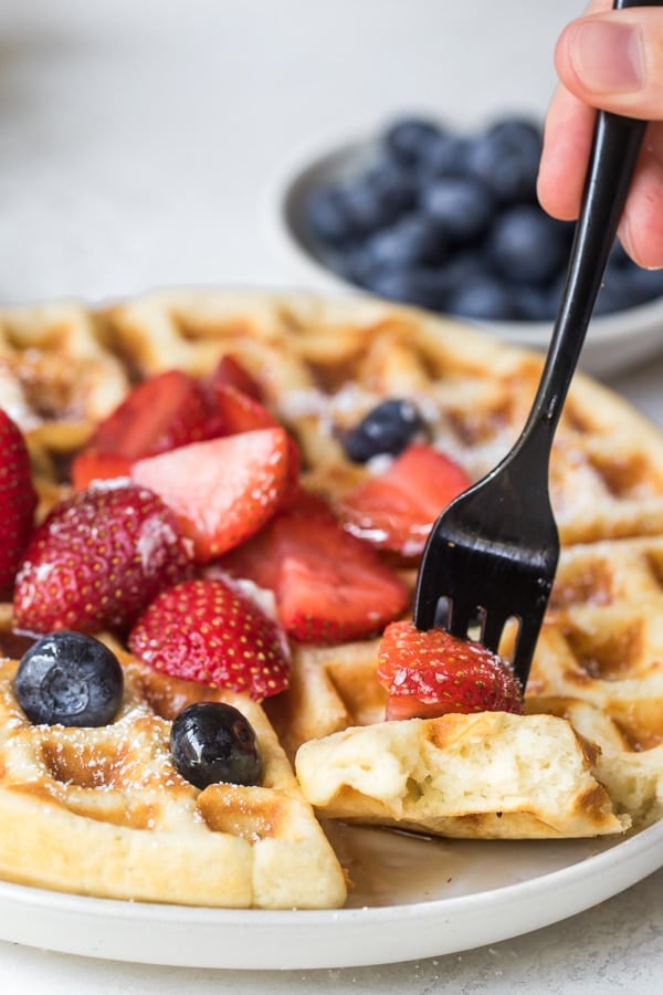 waffle on a plate topped with fresh berries
