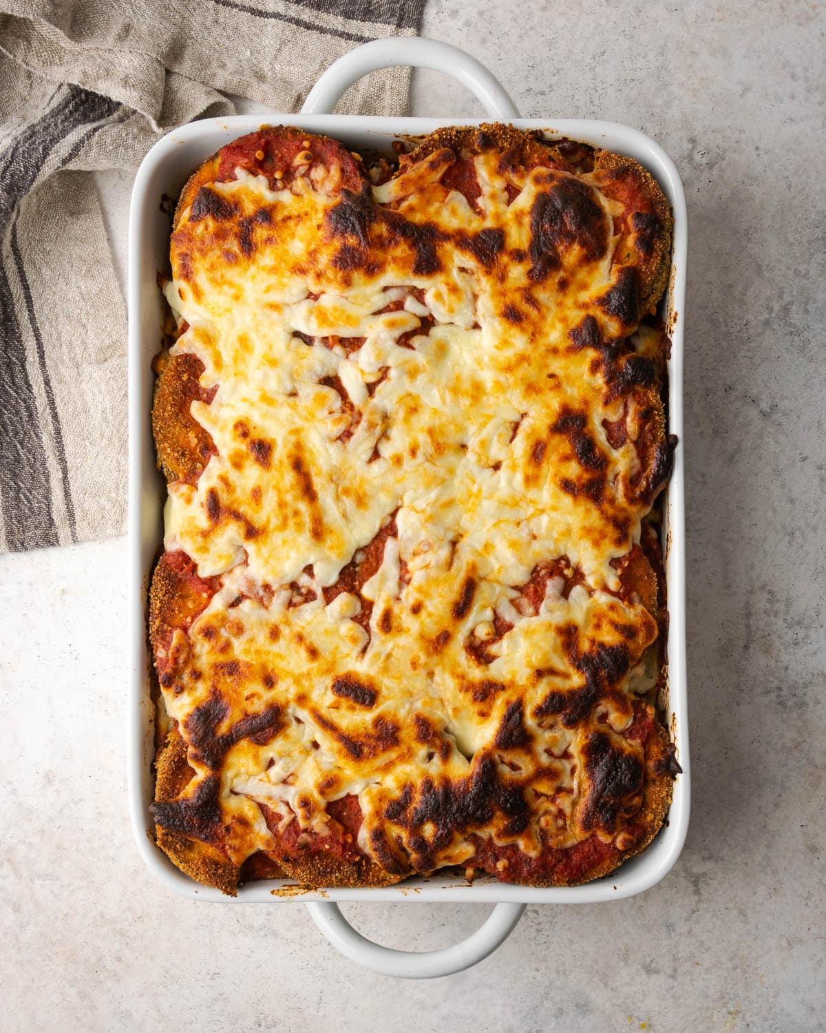 eggplant in a casserole dish topped with cheese