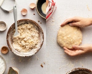 Forming the maple scone dough in a bowl, then shaping it into a round disc on a floured surface with hands.