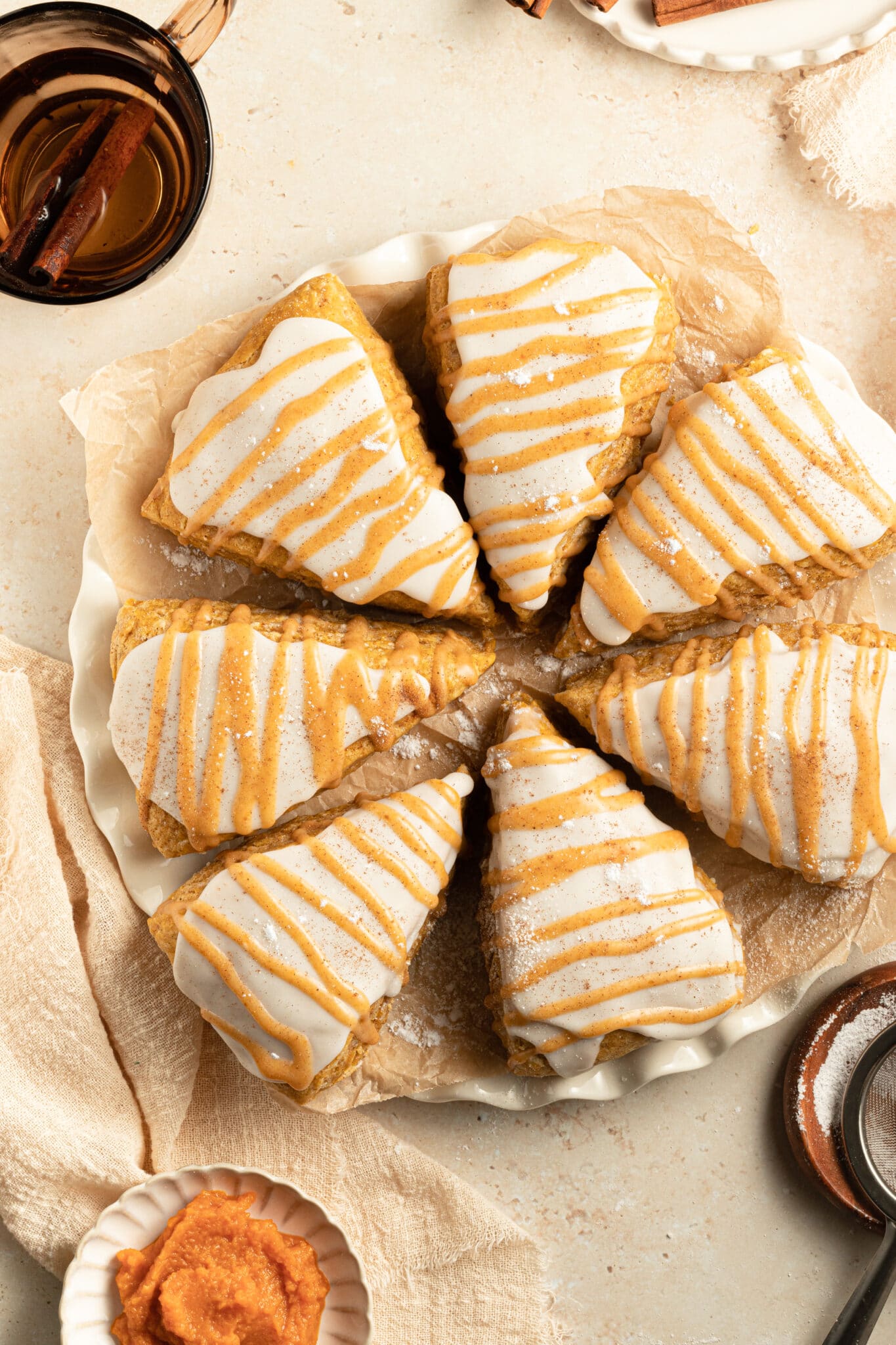 pumpkin scones with glaze on top.