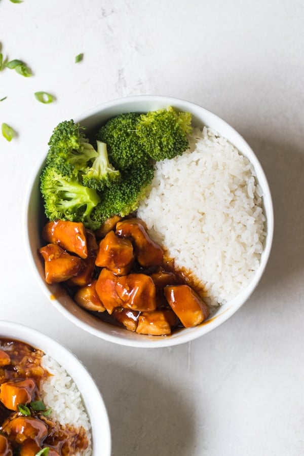 a rice bowl filled with rice, chicken and broccoli