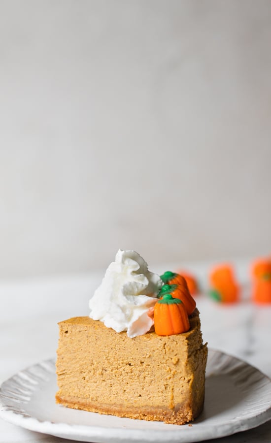 pumpkin cheesecake topped with whipped cream