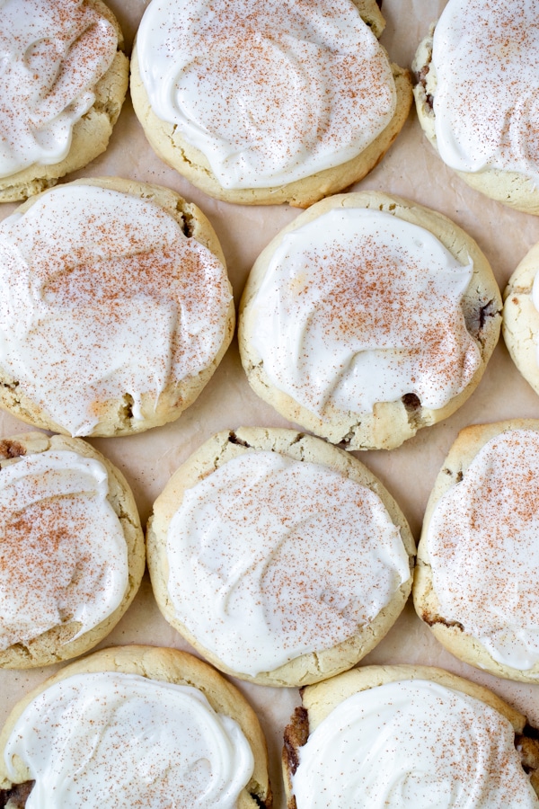 cookies on parchment paper with cream cheese frosting