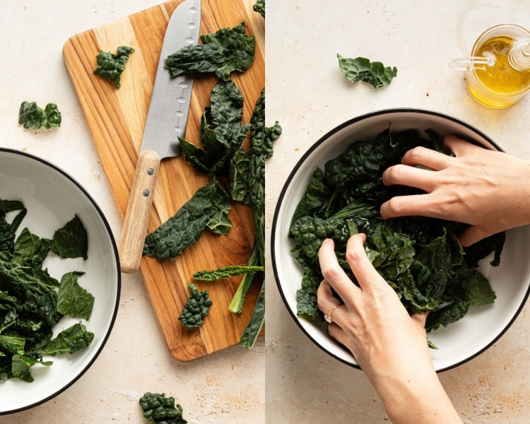 Fresh kale leaves being chopped on a wooden cutting board and massaged in a large white bowl with olive oil for a salad base.
