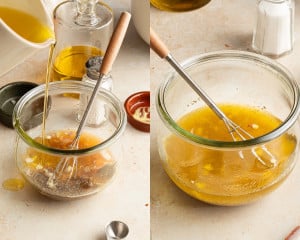 A glass jar filled with a vinaigrette mixture of olive oil, honey, Dijon mustard, shallots, lemon juice, and sherry vinegar being whisked together until emulsified.