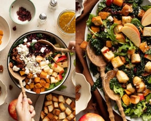 Fall panzanella salad being assembled with kale, roasted butternut squash, apples, feta, cranberries, pecans, and toasted bread cubes, then tossed with vinaigrette.
