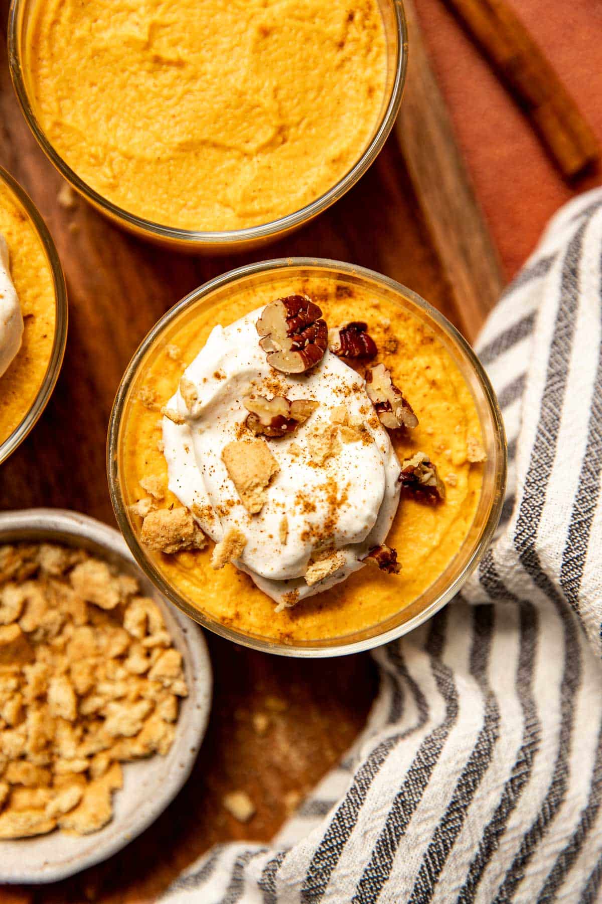 pumpkin mousse topped with whipped cream, pecans, and cinnamon. 