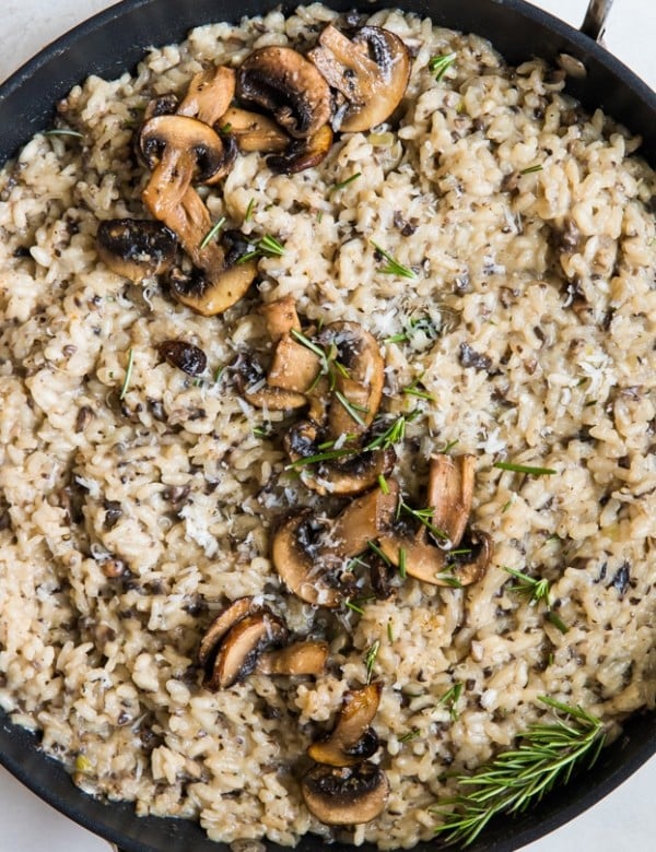 risotto topped with mushrooms in a pan