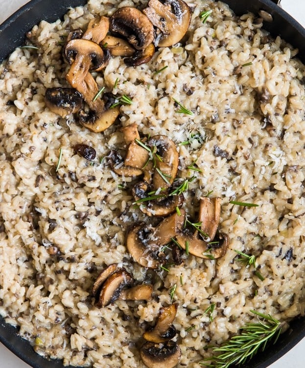 risotto topped with mushrooms in a pan