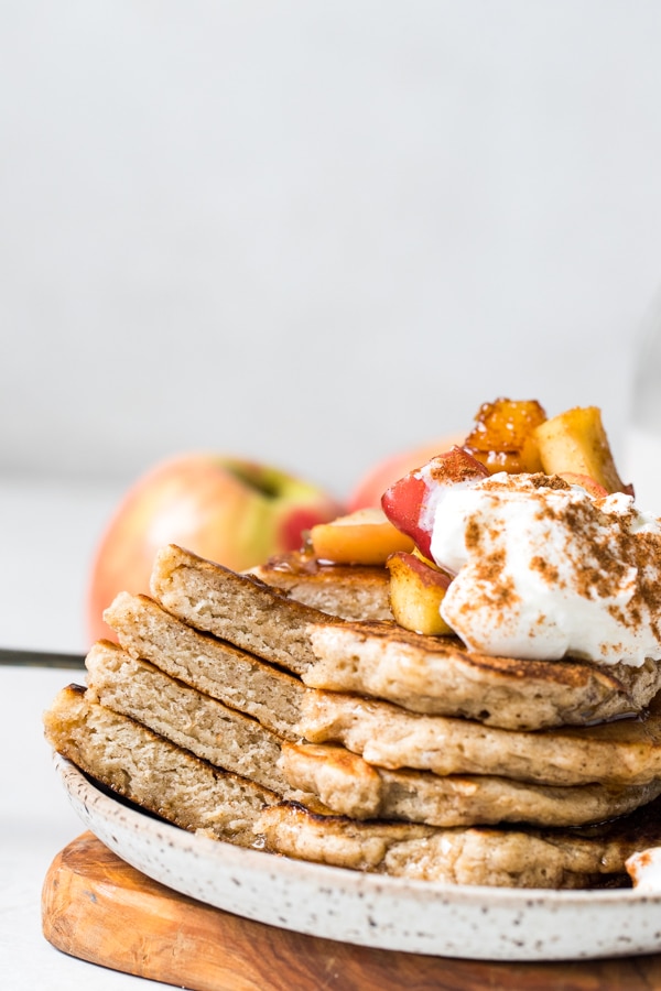 pancakes on a plate with yogurt and apples on top