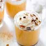 pumpkin mousse in a glass topped with whipped cream and pecans