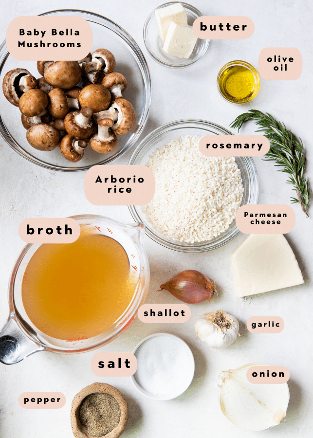 ingredients on a white board needed to make risotto with mushrooms