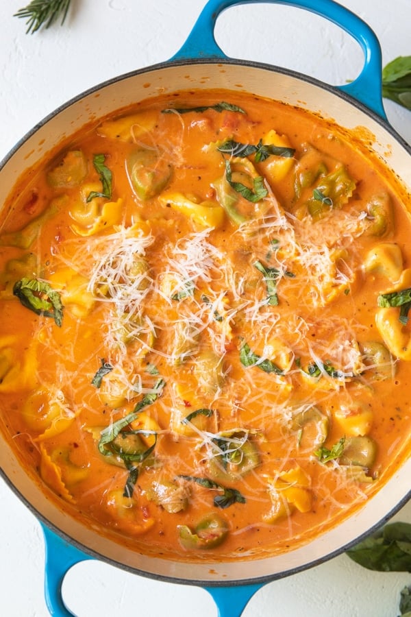 tomato soup with tortellini in a large blue Dutch oven