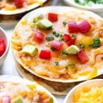 mexican pizza topped with tomatoes and avocado