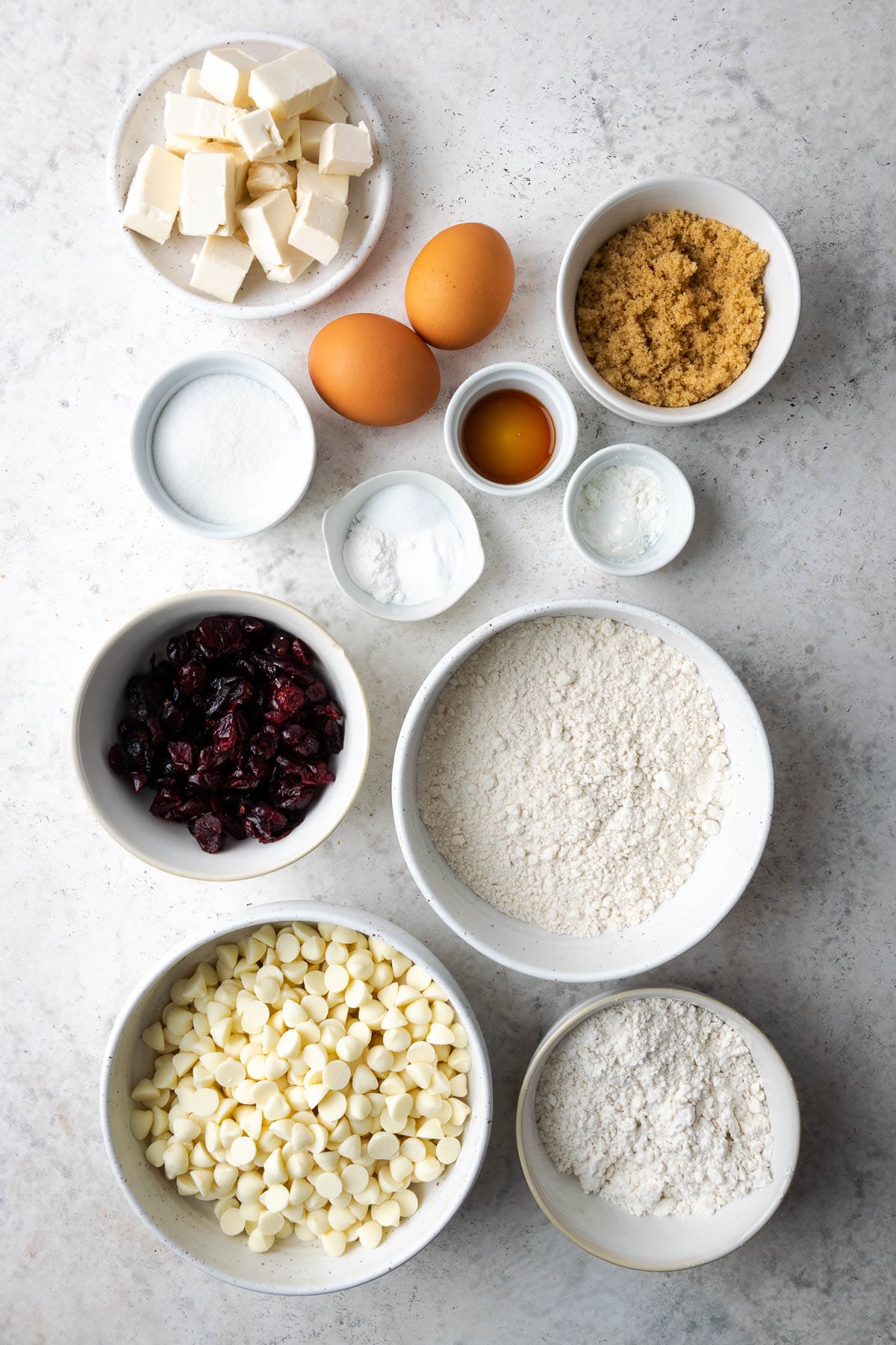 ingredients needed to make cookies in white bowls