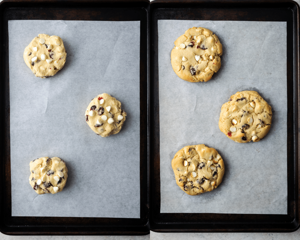 3 cookies with white chocolate chips and cranberries on a baking sheet