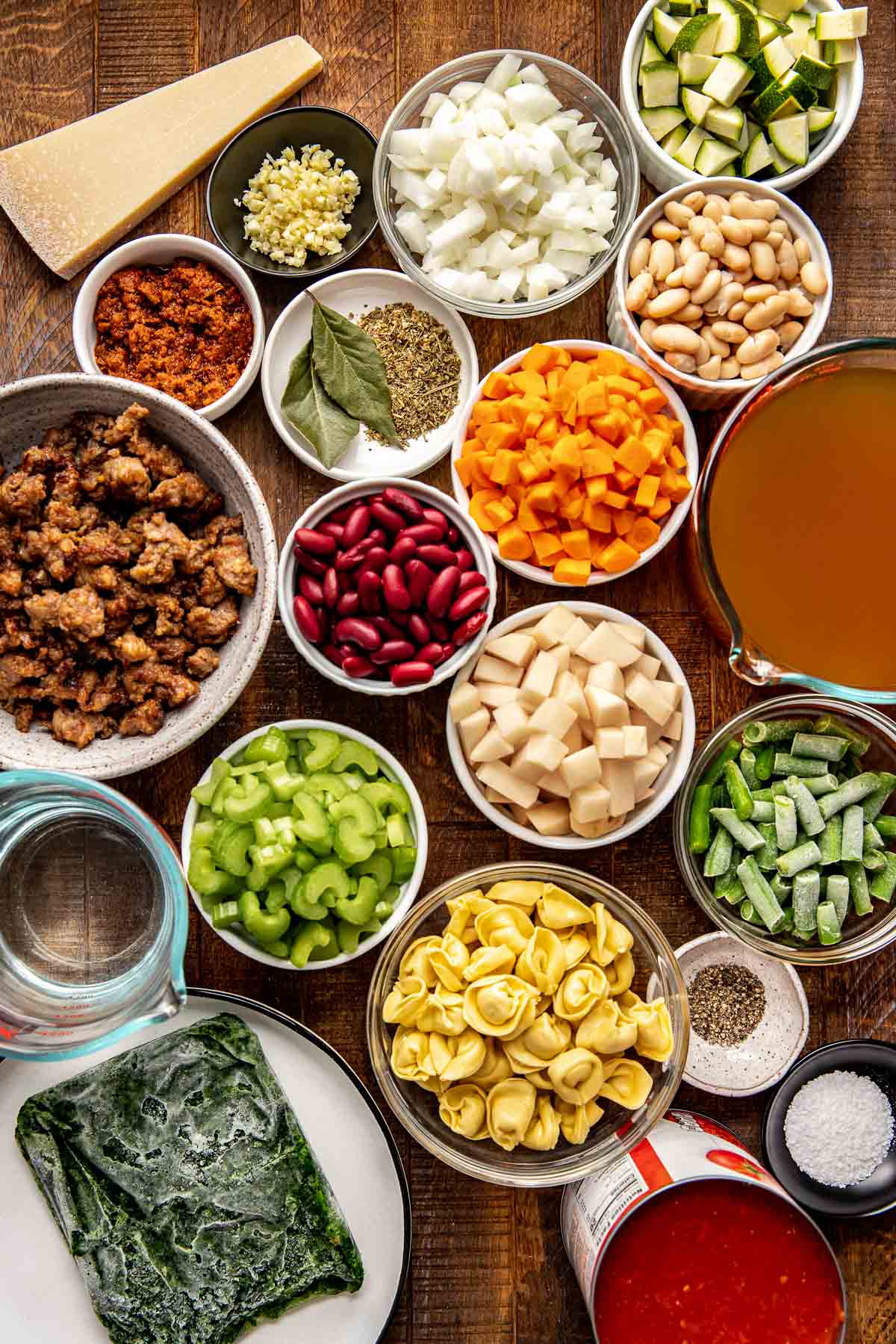 all ingredients prepped and chopped for minestrone soup in small glass dishes. 