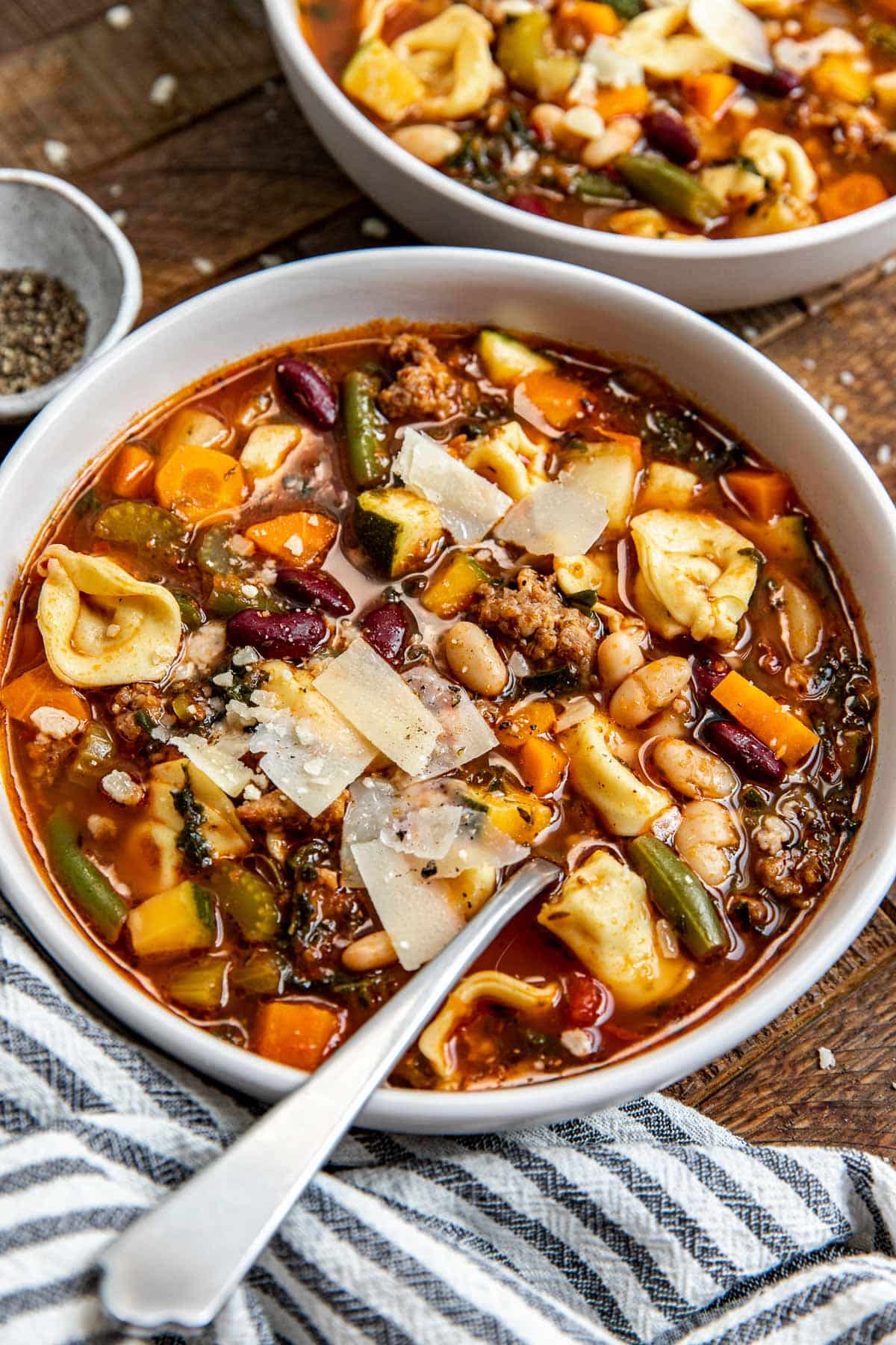 a bowl of minestrone in a white bowl. 