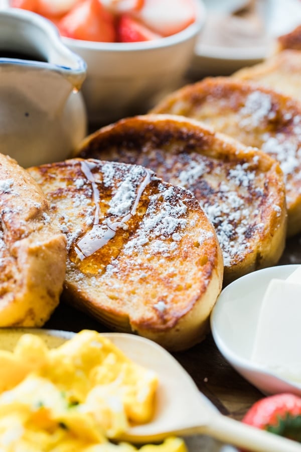 french toast with syrup and powdered sugar on top 