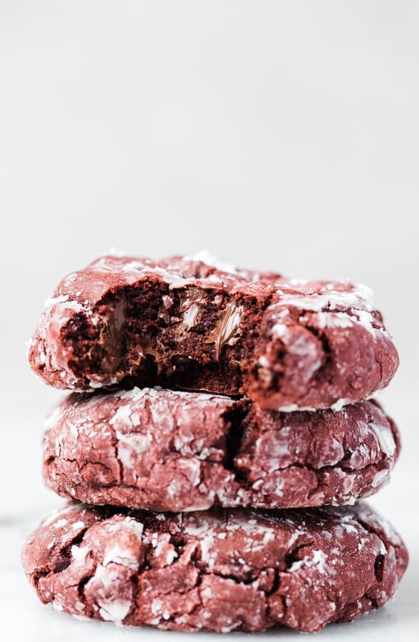 a stack of red velvet crinkle cookies 