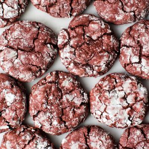 red velvet crinkle cookies on a marble board