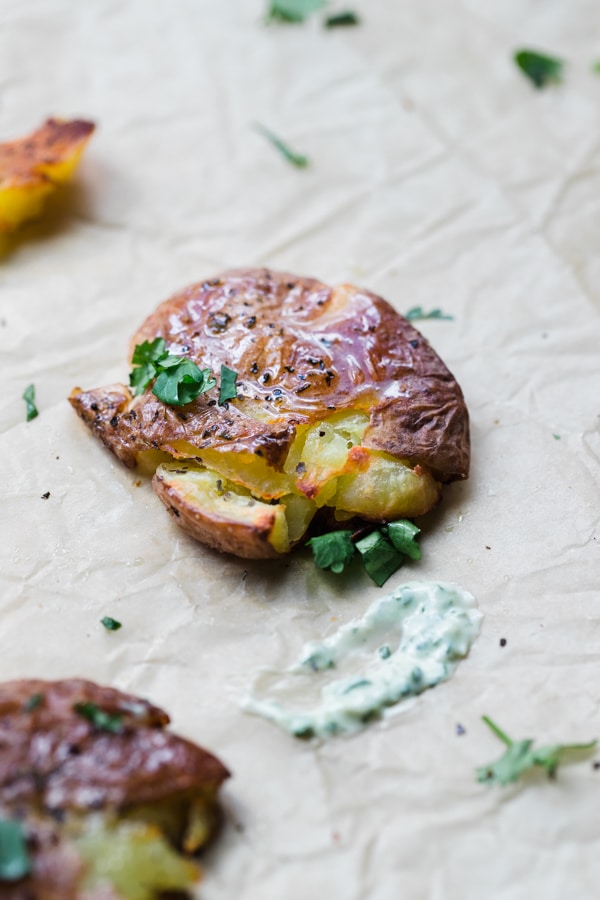 a baby potato topped with olive oil and cilantro